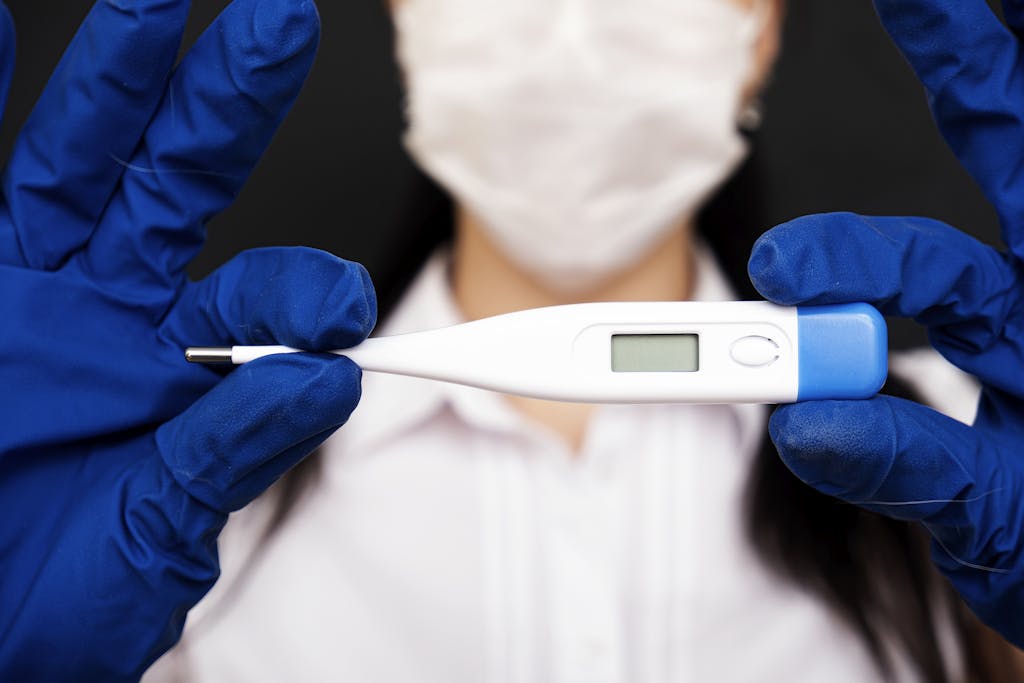Doctor holding a thermometer