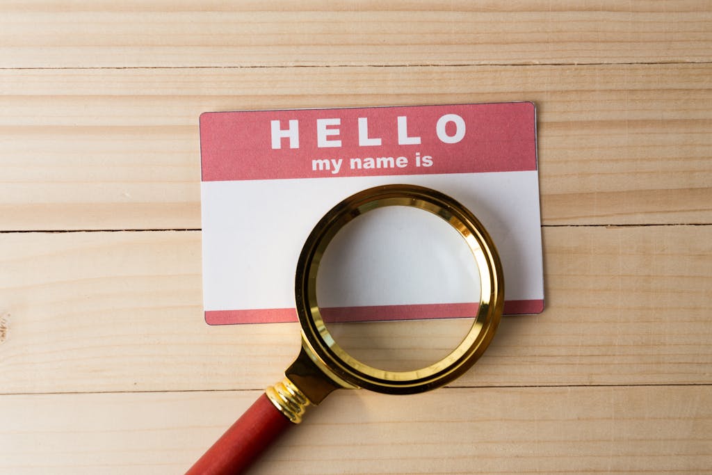 Hello name tag and a magnifying glass